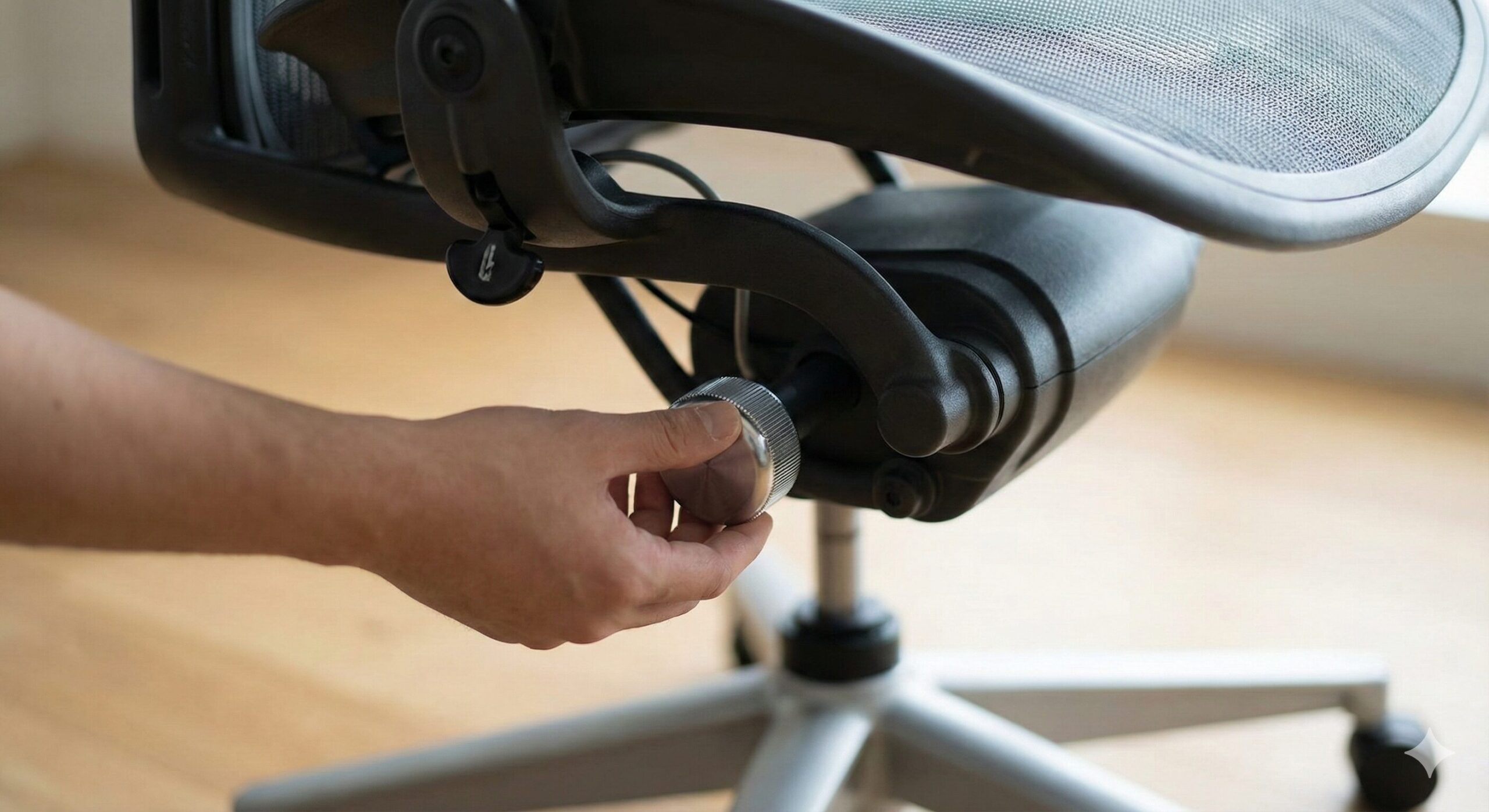 アーロンチェアの各種レバーを操作して最適な座り心地に調整する様子